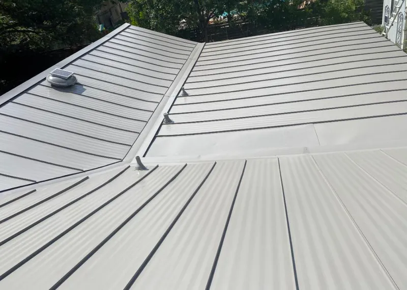 Solar attic fan installed on a metal roof for Roof Ventilation in Lakes of the Four Seasons