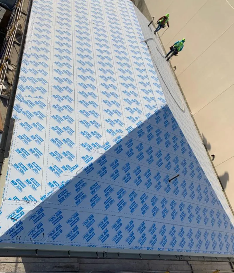 Professional roofers installing underlayment on a metal roof in Lakes of the Four Seasons